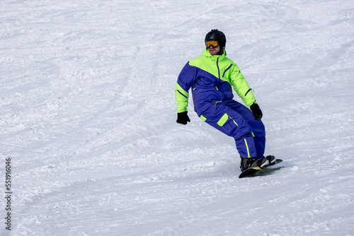 Snowboarder on the slope. Opening of the ski season