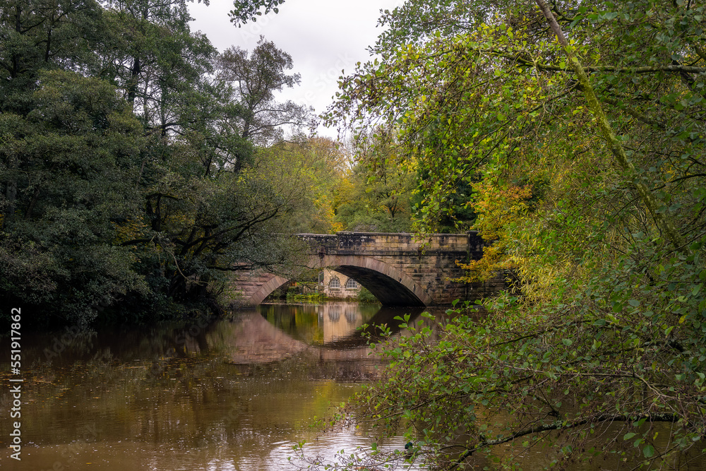 Walking along the river Derwent in autumn, view of New bridge and the Shuttle house, Derbyshire, England Walking along the river Derwent in autumn, view of New bridge and the Shuttle house, Derbyshire, England