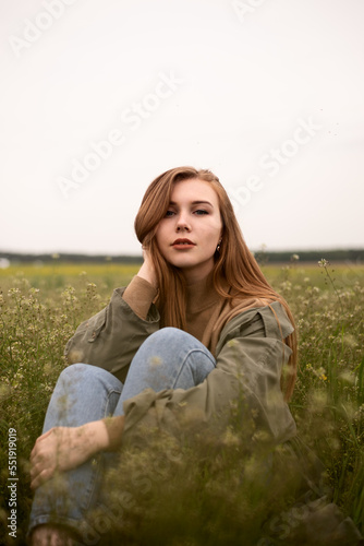 Cheerful girl in the field in summer