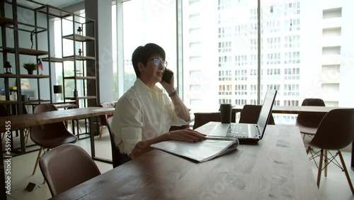 Attractive mature businesswoman working on laptop in office or coworking