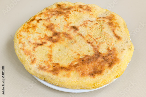 Freshly baked appetizing Turkish tortillas - Gozleme with spinach, cheese  on a wooden board. Space for text. Shallow depth of  field. Handmade Turkish traditional pastries.