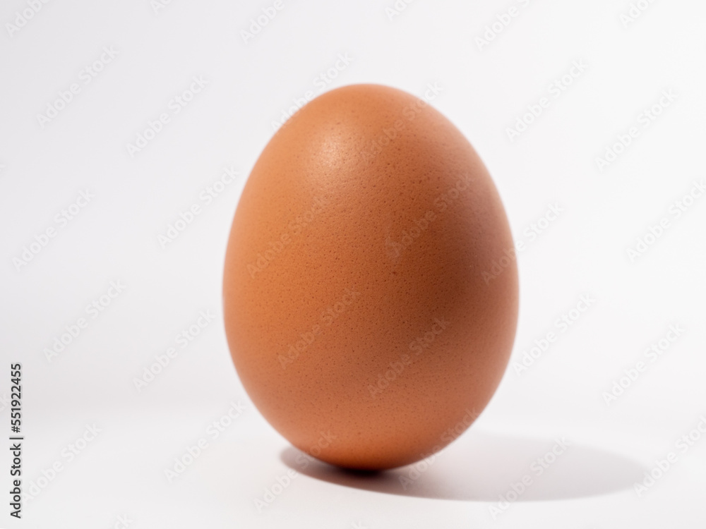 Chicken eggs on a white background. Brown egg on a white background. Chicken eggs on a white background. Brown egg on a white background.
