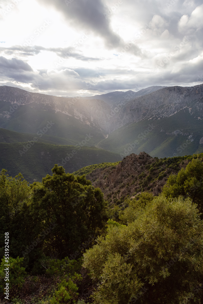 Obraz premium Mountain Landscape Background. Sunset Sky with Sunrays. Near Dorgali, Sardinia, Italy.