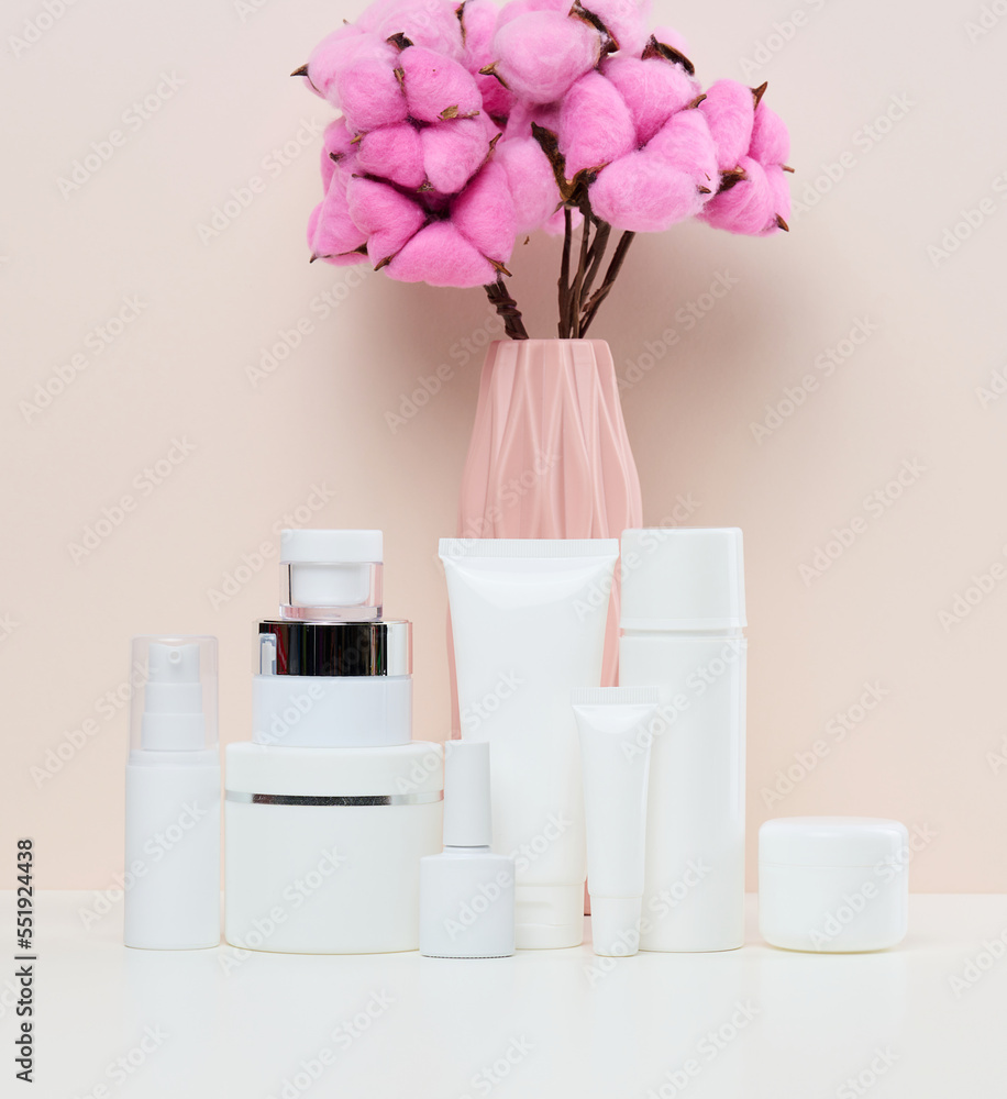 White plastic jars and tubes for liquid cosmetics on a white background. Branding, advertising White plastic jars and tubes for liquid cosmetics on a white background. Branding, advertising