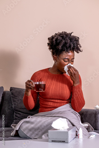 Obraz na płótnie Woman sitting on a sofa, feeling sick