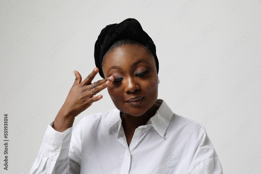 Muslim young woman wearing formal white shirt and hijab posing indoor ...
