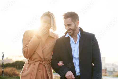 Happy middle-aged marriage walking and talking together. Smiling couple having fun. Good memories of a couple relationship. Portrait of a wife and husband outdoors.