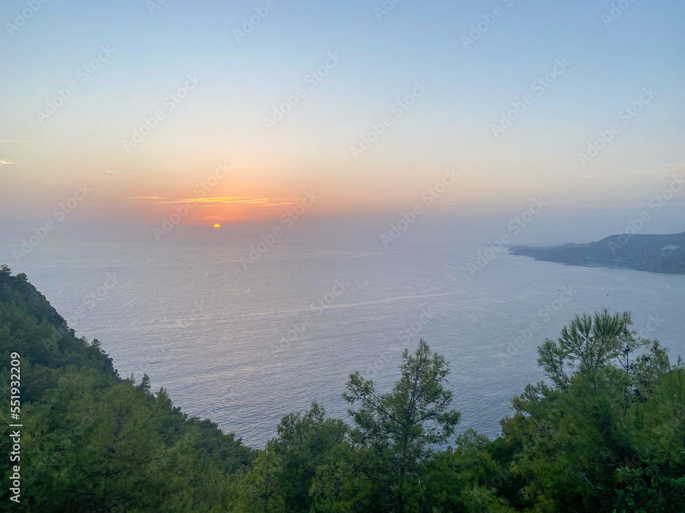 Tourist view from the mountain from a height to the peninsula seashore and green trees at sunset in Turkey on vacation in a paradise warm eastern tropical country resort