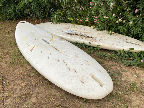 Two white surfing boards lie on the ground in the paradise warm eastern tropical country of the resort.