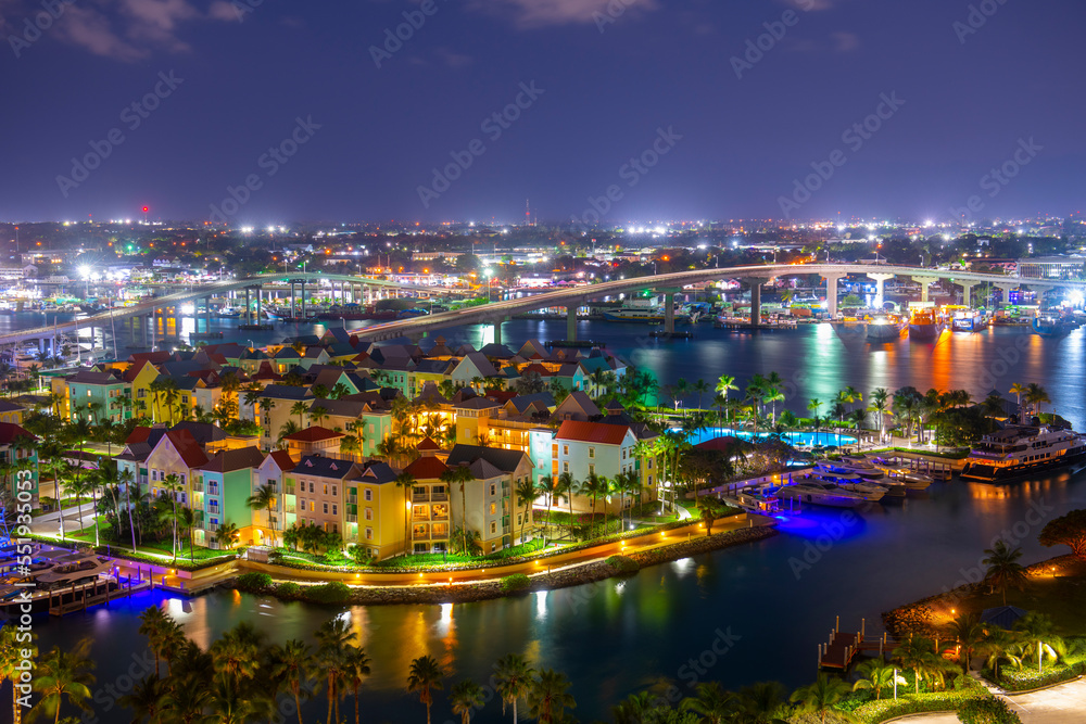 Harborside Villas aerial view at Nassau Harbour with Nassau downtown at the background at night, from Paradise Island, Bahamas.