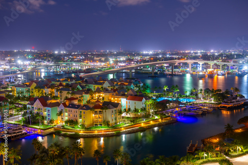 Harborside Villas aerial view at Nassau Harbour with Nassau downtown at the background at night, from Paradise Island, Bahamas.