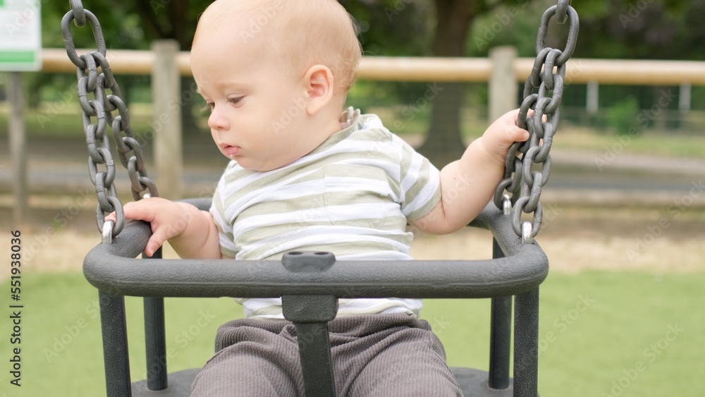 Funny Little Younger Newborn Infant Brother Boy On Swing. Baby Playing On Playground. Summer time outside. Kids Entertainment, Childhood, Child Development, Happy Family Concept Funny Little Younger Newborn Infant Brother Boy On Swing. Baby Playing On Playground. Summer time outside. Kids Entertainment, Childhood, Child Development, Happy Family Concept