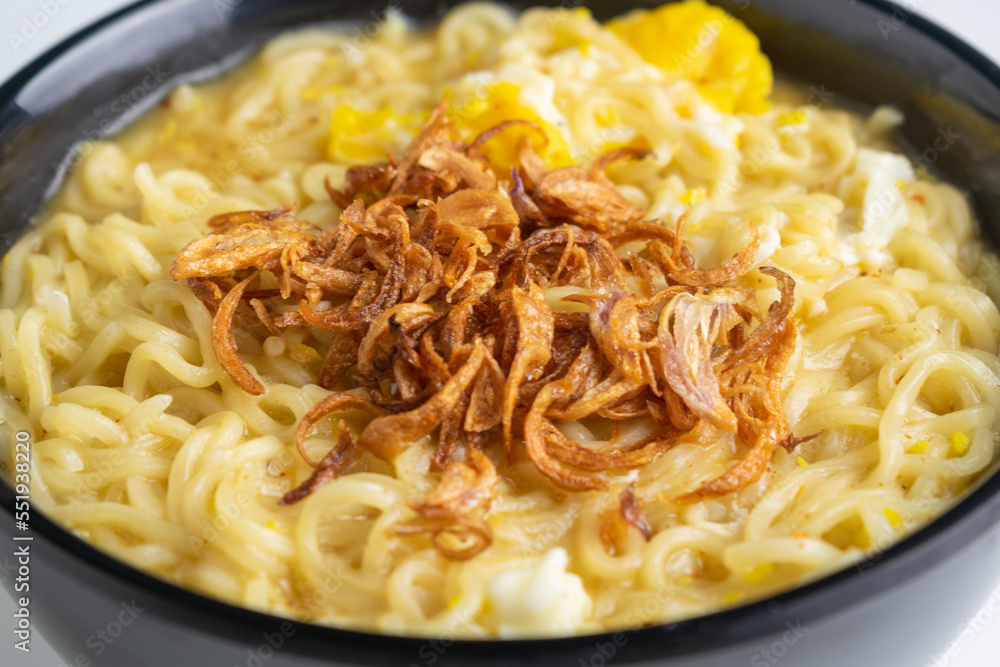 instant noodle with fried shallots on black bowl with chopstick instant noodle with fried shallots on black bowl with chopstick