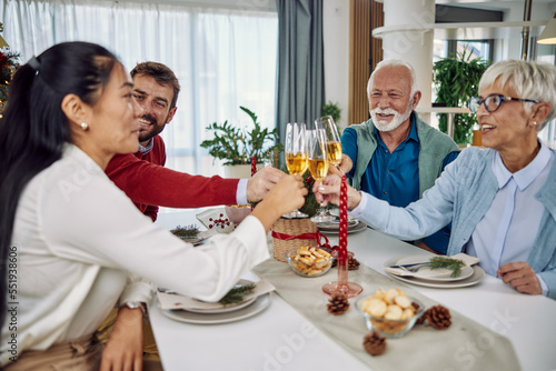 Family toasting at christmas dinner in the dinning room