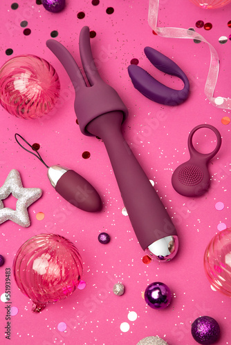 New Year or Christmas festive background for Sex shop Top view on sex toys and Christmas decor Image for the festive season and sales Adult store Dildo Vibrator Vaginal Balls Clitoral Massager 