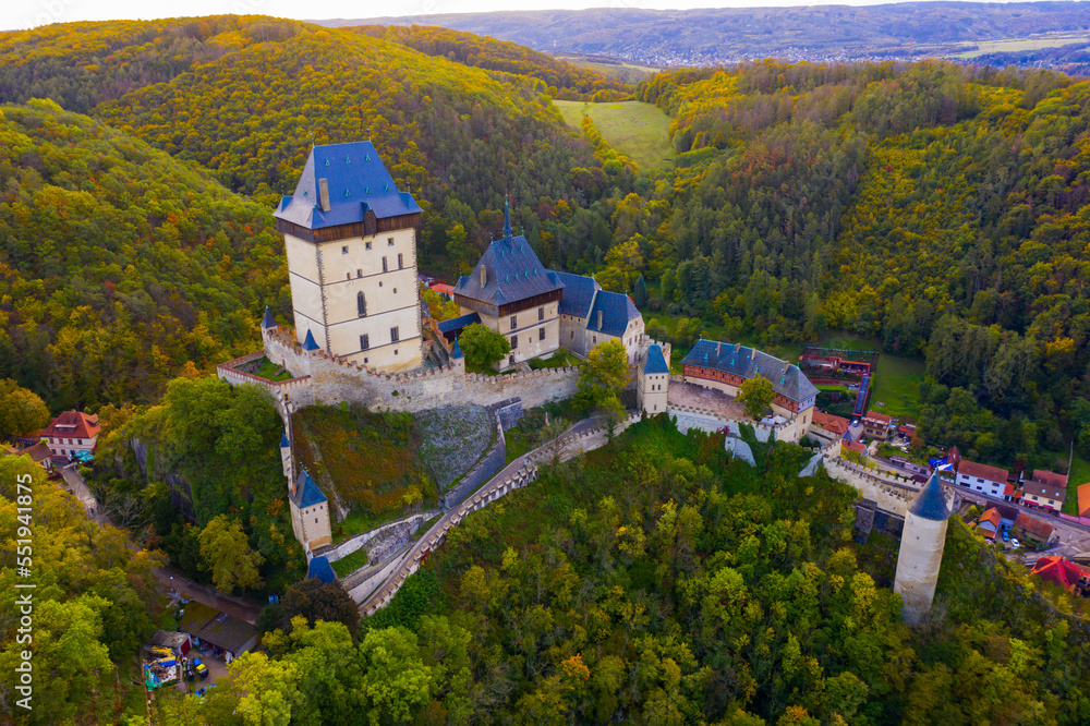 Aerial view of medieval Karlstejn castle in autumn park, Czech Republic