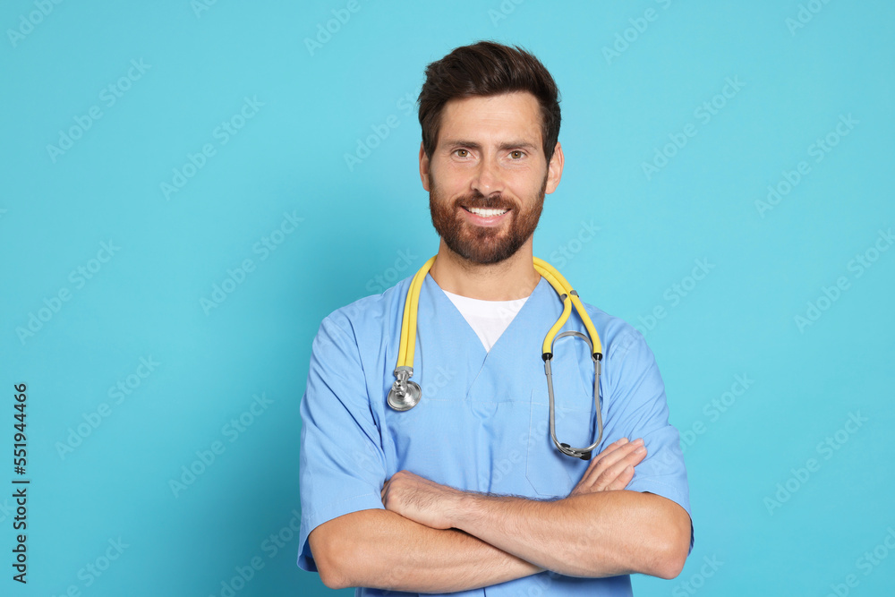 Happy doctor with stethoscope on light blue background Happy doctor with stethoscope on light blue background