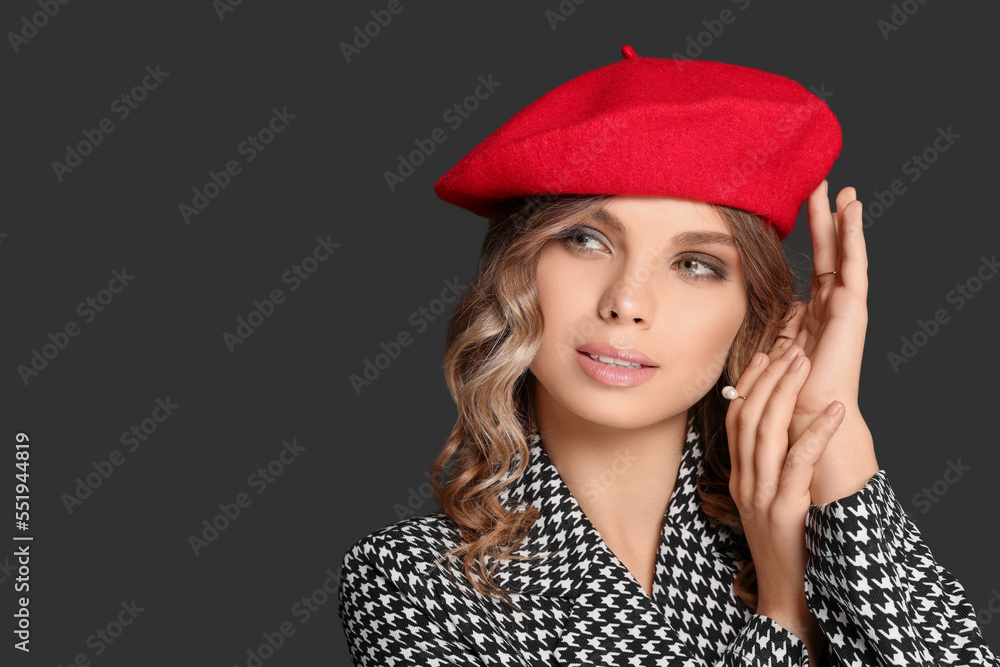 Young woman with beautiful makeup in red beret against black background. Space for text Young woman with beautiful makeup in red beret against black background. Space for text