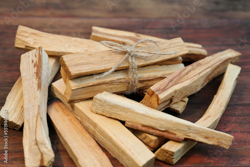 Many palo santo sticks on wooden table, closeup