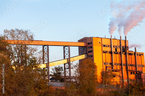 Raw coal drying in a factory. Belts for transport to the thermal power plant. Smoke pollutes the environment. photo