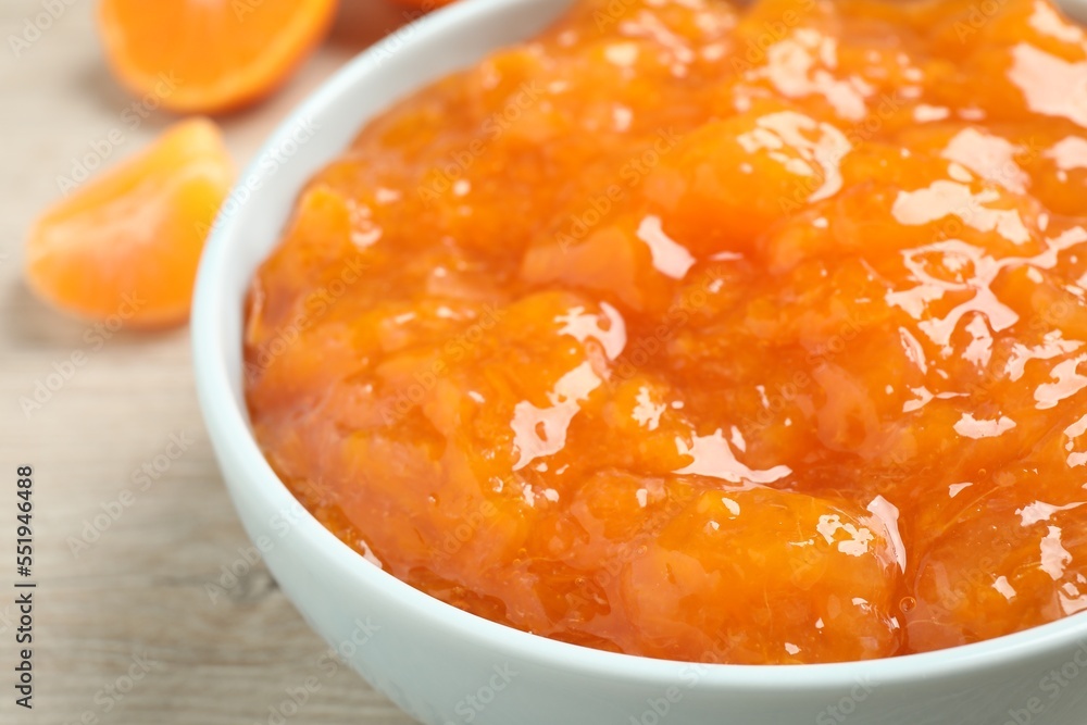 Delicious tangerine jam in bowl on table, closeup Delicious tangerine jam in bowl on table, closeup