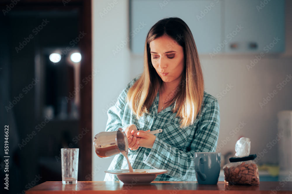 Woman Making Breakfast Pouring Milk Over Cereal. Morning person making a meal in the kitchen 
