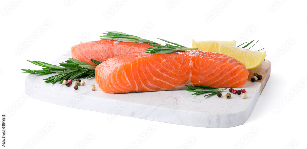 Pieces of fresh raw salmon, spices and lemon slices on white background Pieces of fresh raw salmon, spices and lemon slices on white background