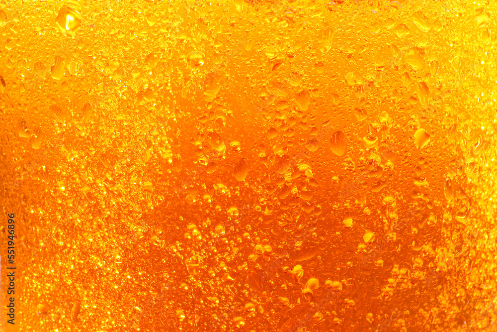 Glass of tasty cold beer with condensation drops as background, closeup Glass of tasty cold beer with condensation drops as background, closeup