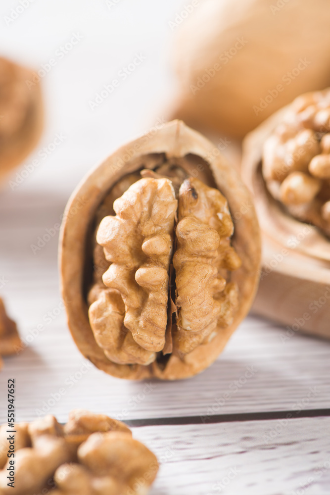 Fototapeta premium Walnut kernels nut on wooden table.