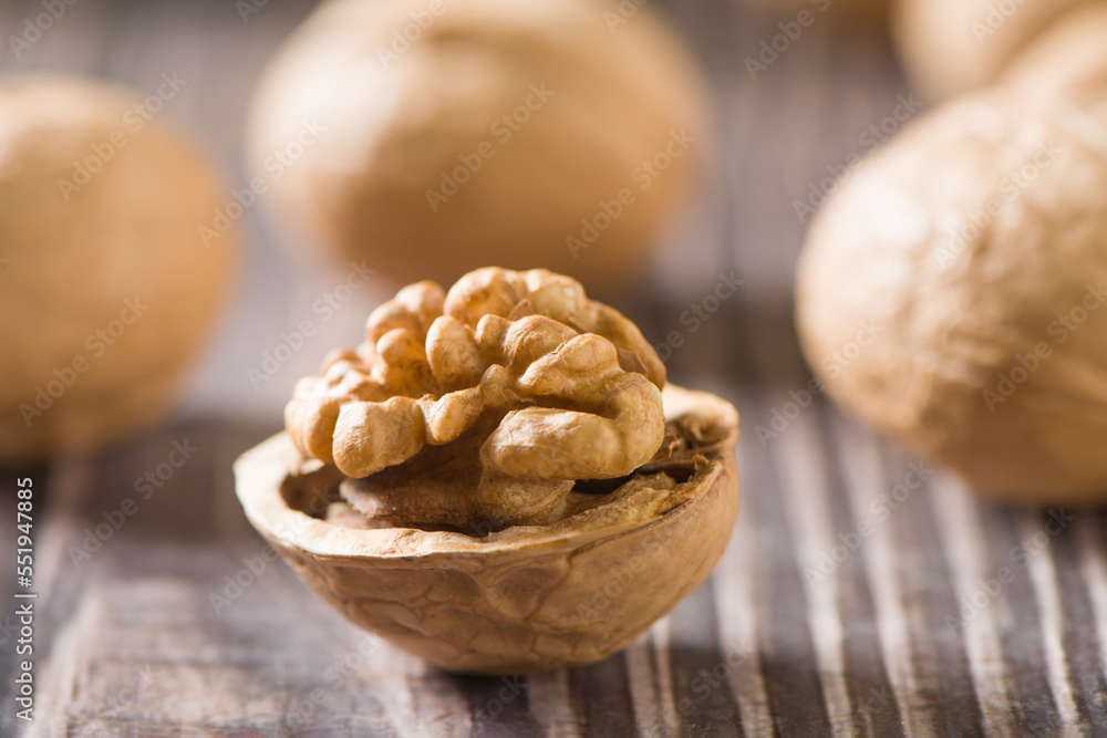 Walnut kernels and whole walnuts on wooden table. Walnut kernels and whole walnuts on wooden table.
