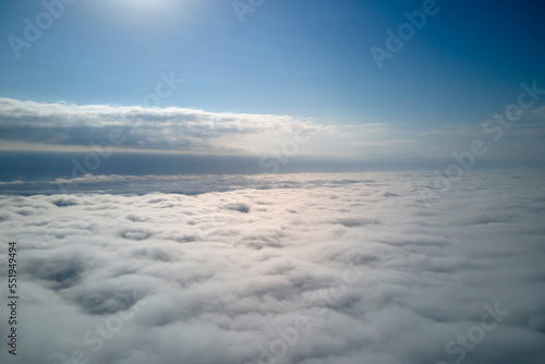 Aerial view from high altitude of earth covered with puffy rainy clouds forming before rainstorm