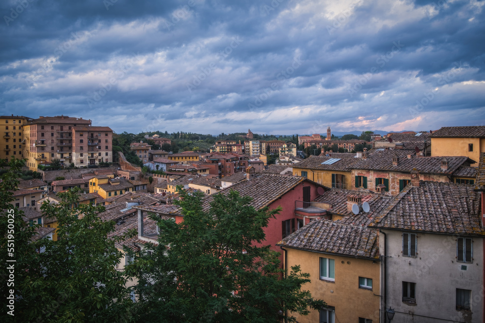 Beautiful panoramic view of the historic city of Siena at daytime with an amazing cloudscape on an idyllic autumn evening, Tuscany, Italy. Long exposure picture. October 2022