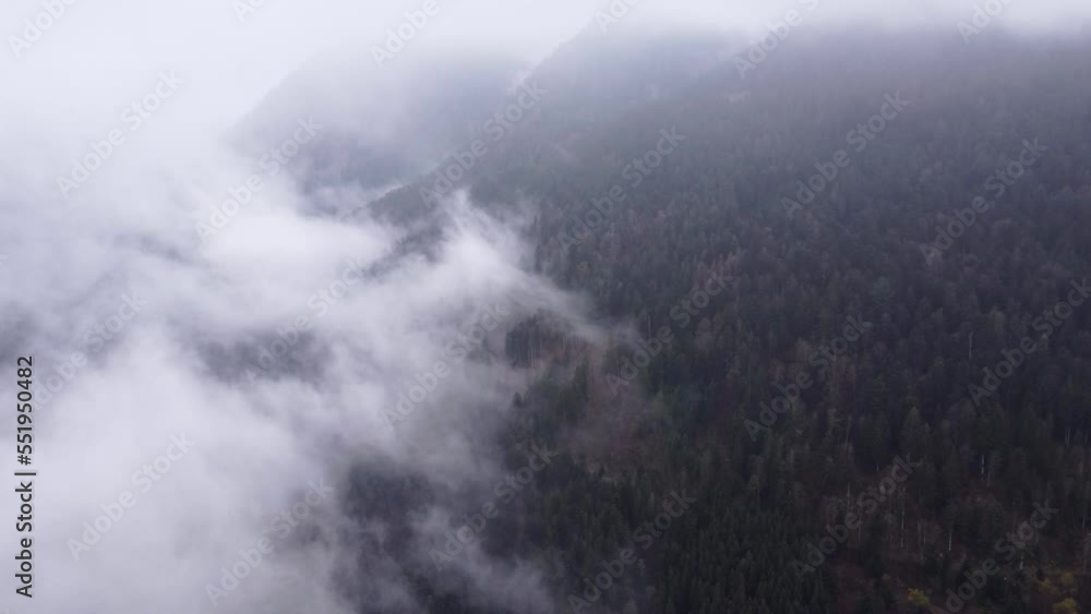 Aerial view of a mountain dark valley with moving clouds during autumn fall in Vosges, France, 4K Aerial view of a mountain dark valley with moving clouds during autumn fall in Vosges, France, 4K
