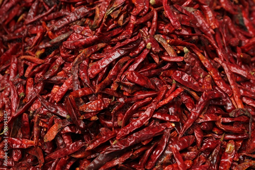 Pile of spicy dried red chiles as background, top view Pile of spicy dried red chiles as background, top view
