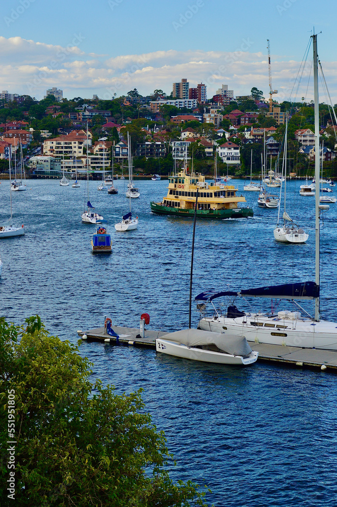 A ferry cruises on Sydney Harbor near Kirribilli in the late afternoon sunshine