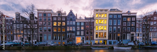 Canvas Print Amsterdam Netherlands canals with lights during the evening in December