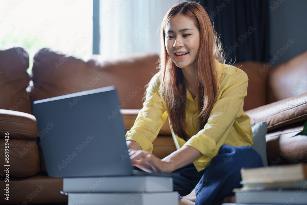 Portrait of a beautiful Asian teenage girl using a computer Portrait of a beautiful Asian teenage girl using a computer