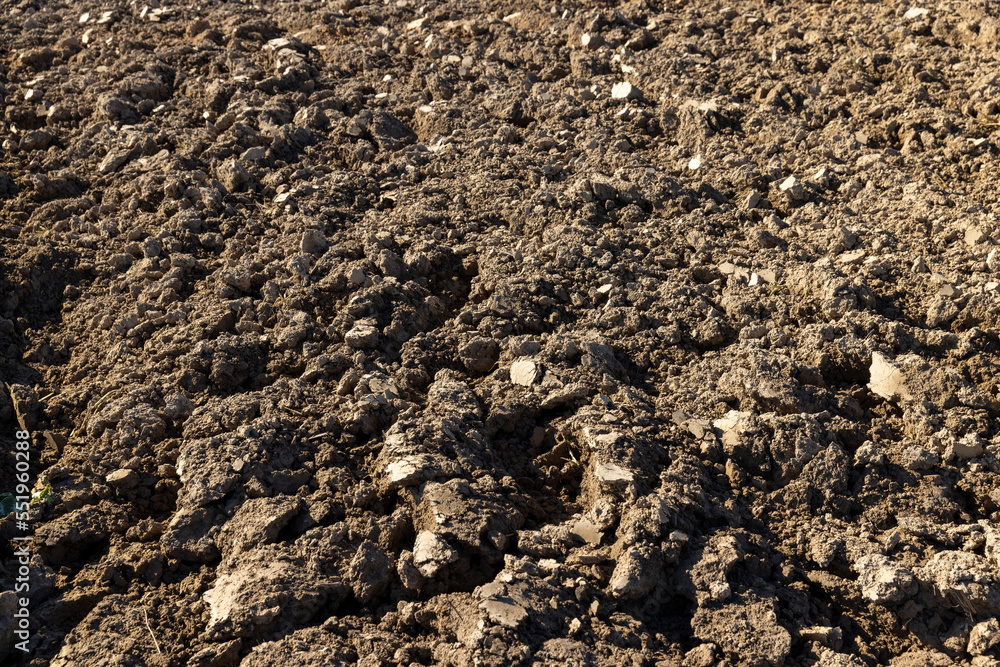 Processed plowed fertile soil in the field Processed plowed fertile soil in the field