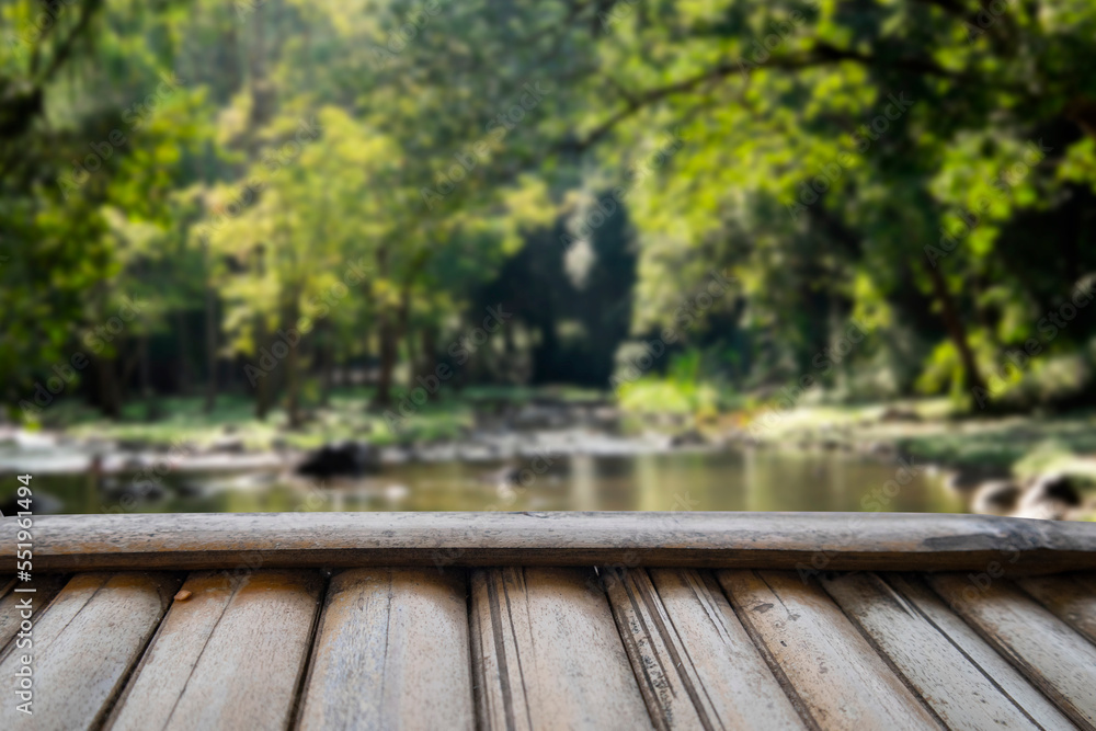 Wood floor and forest blurred background with stream Wood floor and forest blurred background with stream