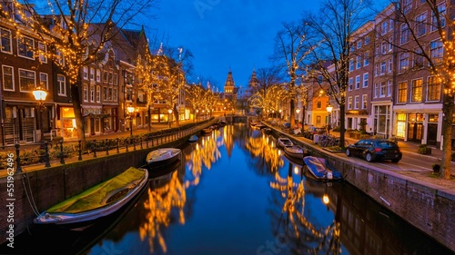 Photography Christmas in Amsterdam canals with Christmas lights during December, Winter evening at the canal historical center of Amsterdam at night