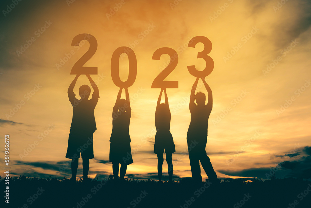 Happy new year 2023 background new year holidays card with bright sunlight, family with arms raised new year 2023.