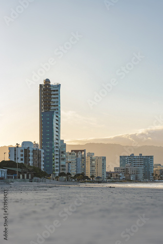 Buildings on Strand Beach in the shade during sunrise © coowikie