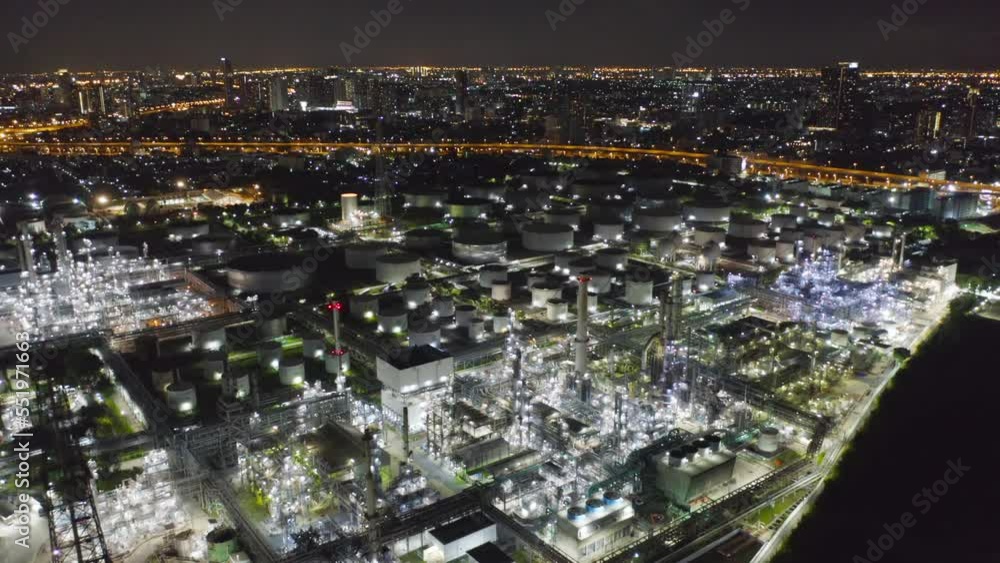 Aerial view of petrochemical oil refinery and sea in industrial engineering concept in Bangna district at night, Bangkok City, Thailand. Oil and gas tanks pipelines in industry. Modern metal factory. Aerial view of petrochemical oil refinery and sea in industrial engineering concept in Bangna district at night, Bangkok City, Thailand. Oil and gas tanks pipelines in industry. Modern metal factory.