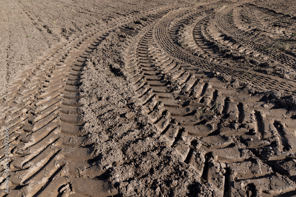 Traces of a tractor or other large machinery on the soil in the field Traces of a tractor or other large machinery on the soil in the field