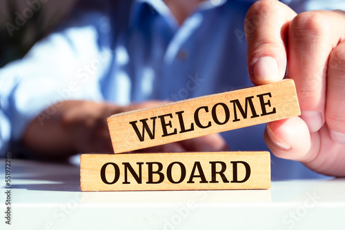 Welcome onboard symbol. Wooden blocks with words 'Welcome onboard'. Business and welcome onboard concept. 