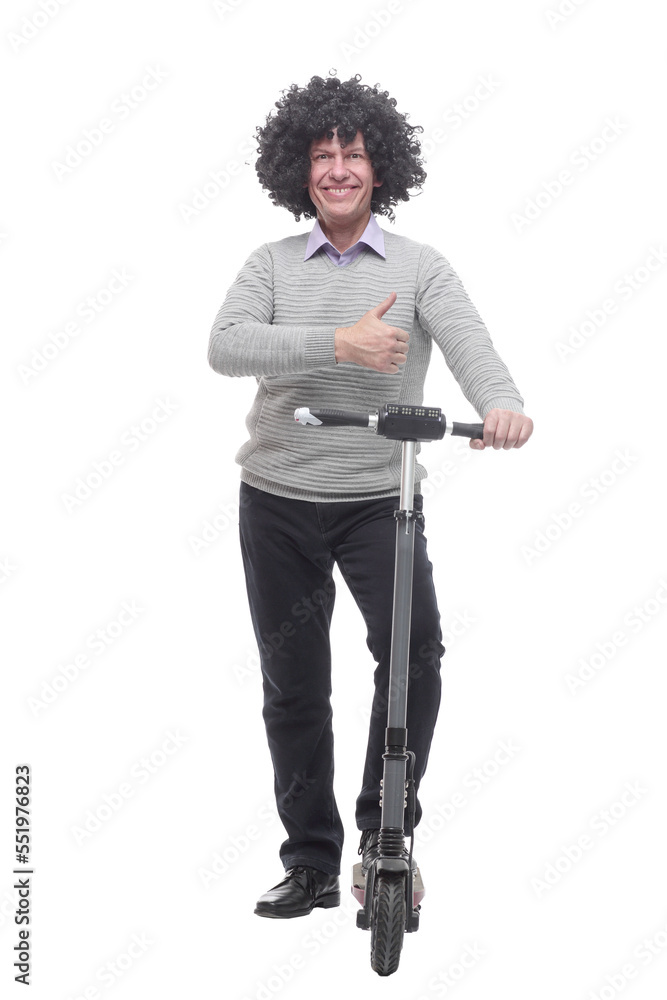 in full growth. cheerful man with an electric scooter. in full growth. cheerful man with an electric scooter.