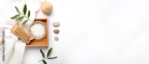 Composition with massage brush, wooden ball and sea salt on white background with space for text