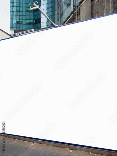 Close-up of blank empty construction hoarding space for advertisement mockup. Construction site area with offices in the background in the central business district.