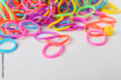 Colorful rubber bands on light background, closeup