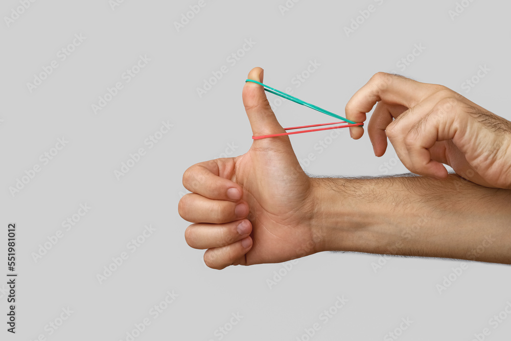 Man with rubber bands on grey background Man with rubber bands on grey background